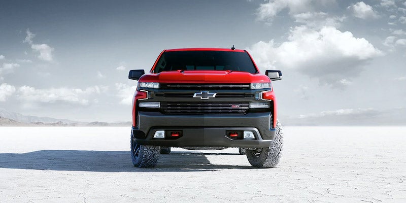 Rear view of Chevrolet Silverado 1500 driving on snowy terrain